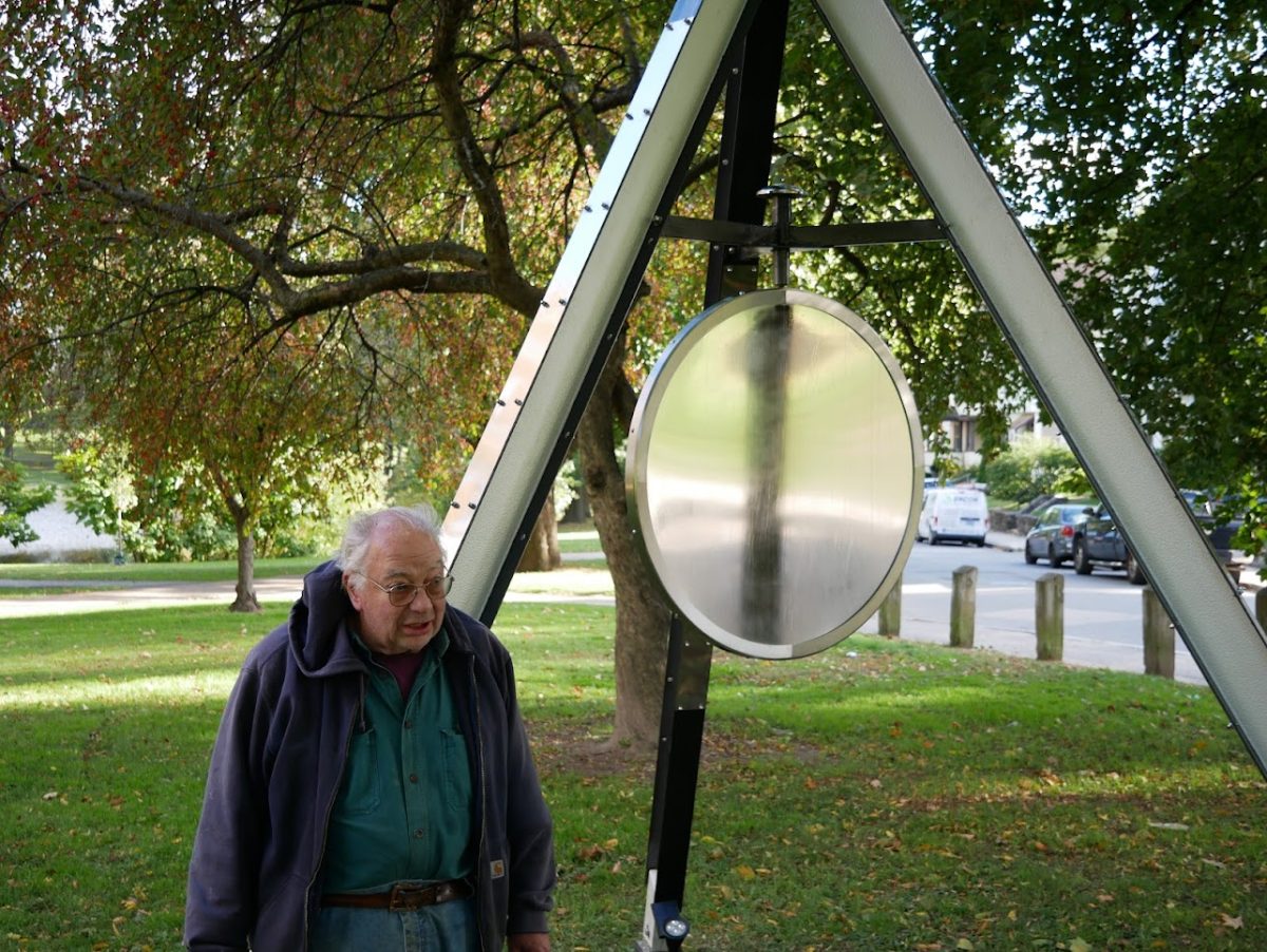 Brendan Stecchini with his piece Reflective Wind in University Park, Worcester, MA.