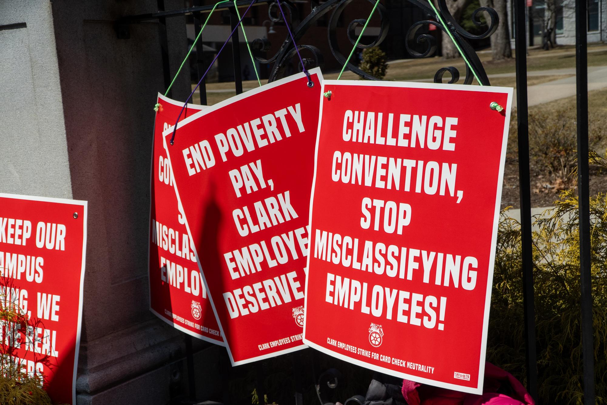 Teamsters signs hanging outside the gate to Clark University