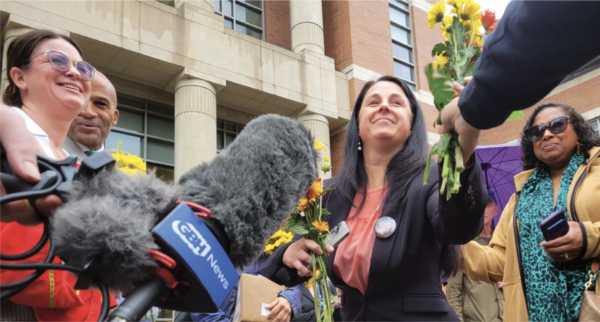 Etel Haxhiaj accepting flowers from a supporter after her court hearing. Ashley Spring on the left.

